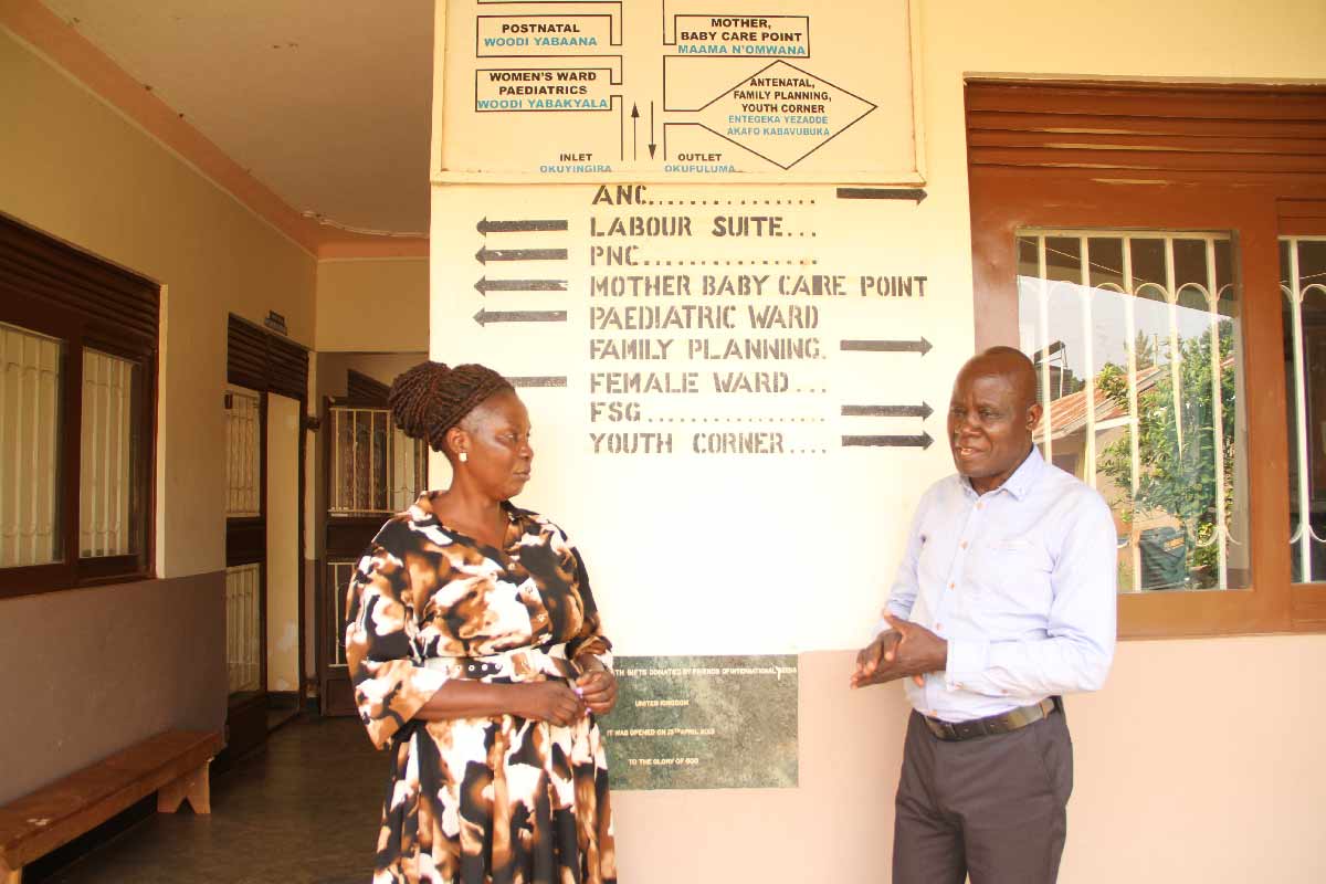 Dorothy Kirunda chats with Grace Tabuzibwa, a fellow CHW, at Makonge Health Centre III. Credit: James Karuga