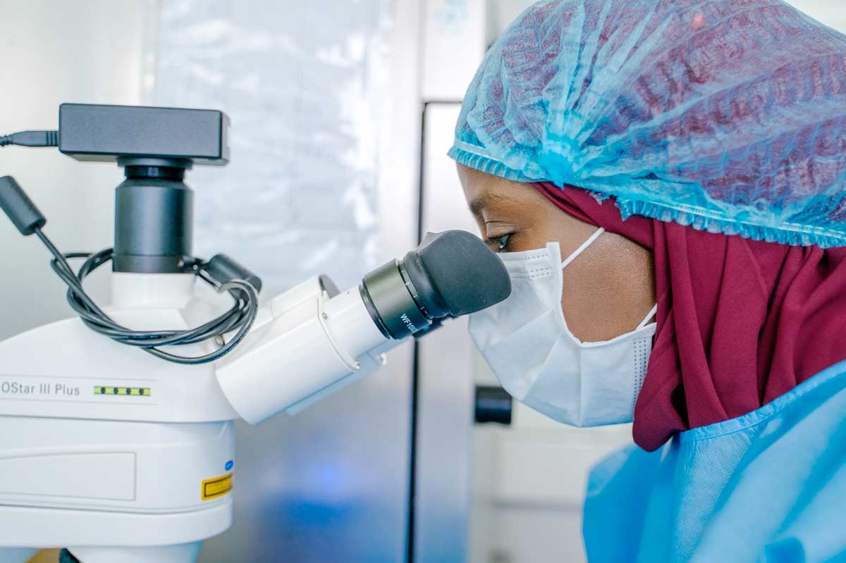 Dr. Sène Marie-Angélique, Head of the Microbiology and Analytical Development Lab, looks through a microscope, at the Institut Pasteur in Dakar, Senegal. Credit: Gates Archive/Carmen Yasmine Abd Ali