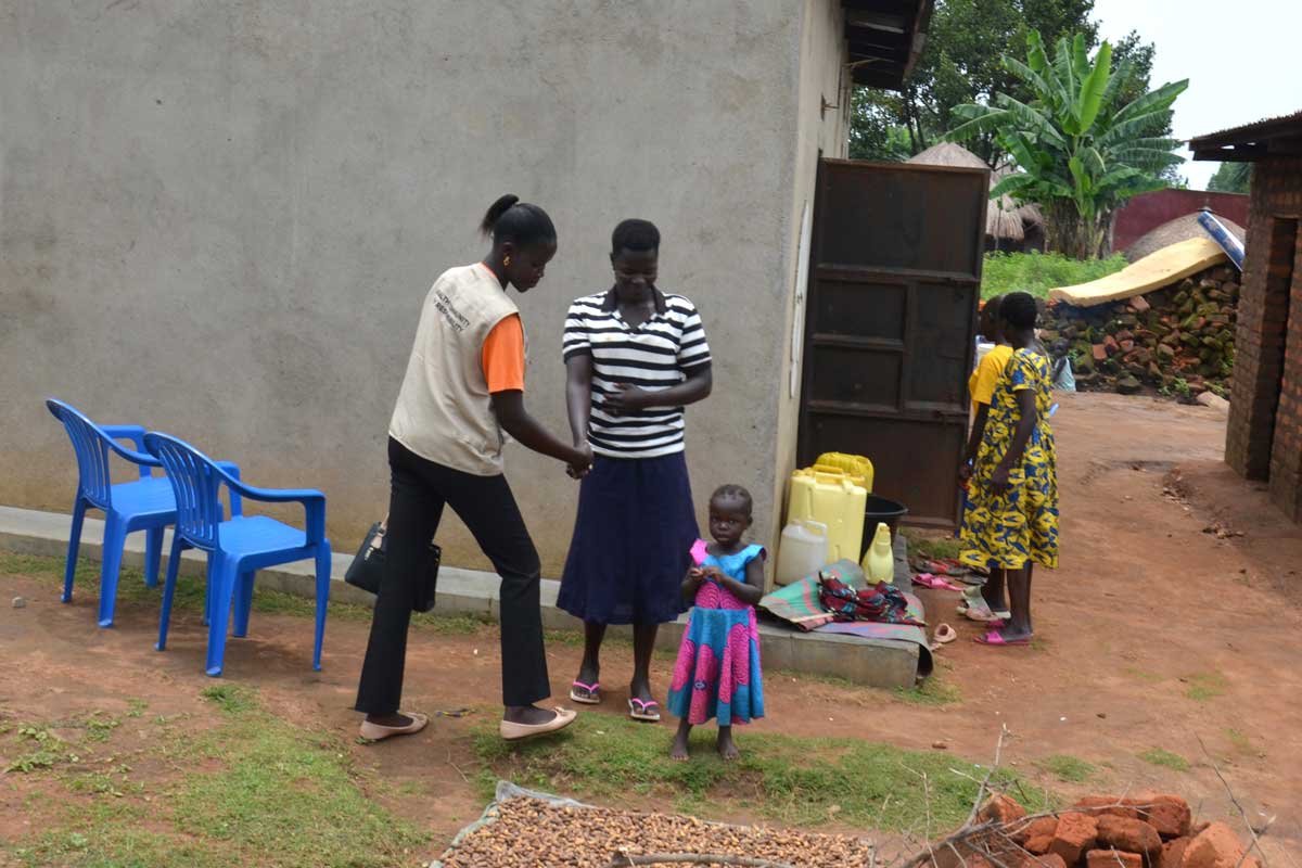 A mother at home in Alivu Parish welcomes a Community Health Extension Worker informing her about the malaria vaccine. Credit: John Musenze