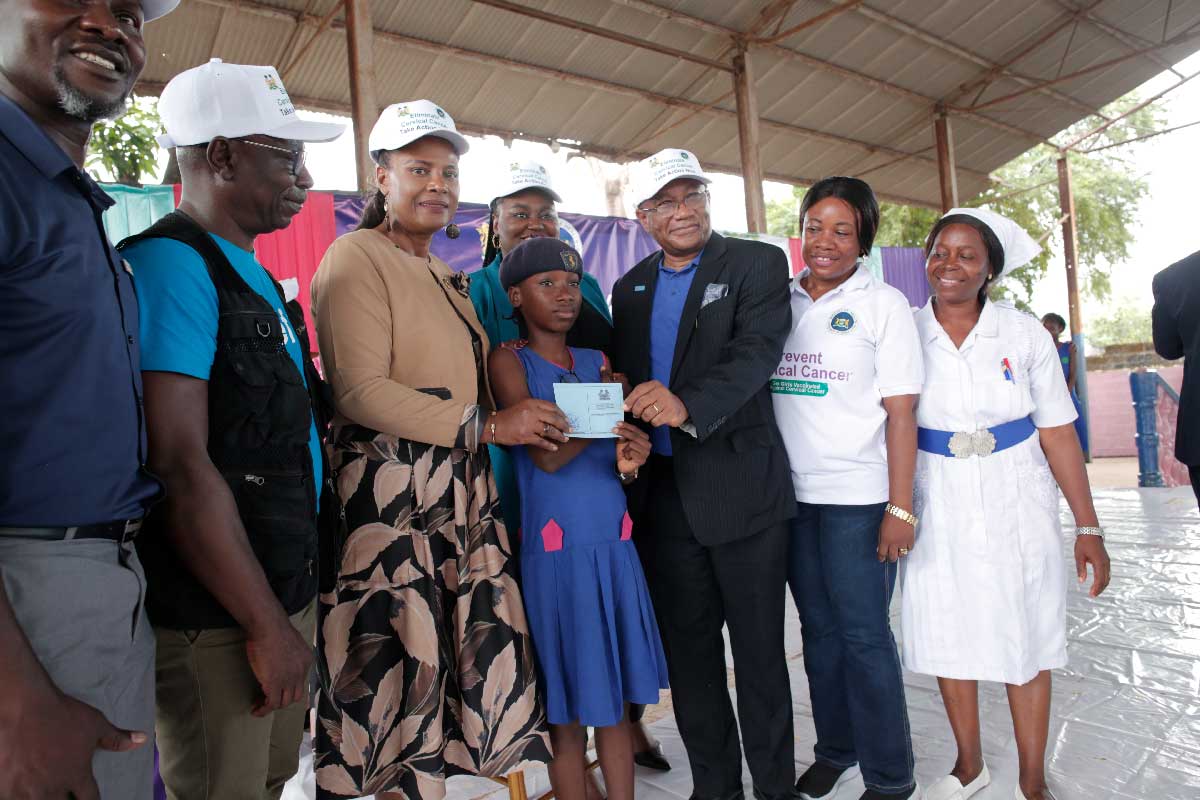 A pupil of the St Joseph Convent Secondary School in Freetown holding her HPV vaccination card. Credit: Saidu Bah