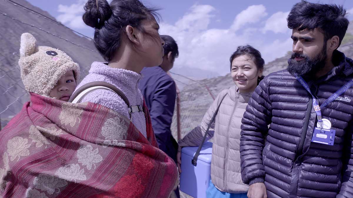 Sanjita and Sushil speak to a mother in Kagbeni village, checking her child’s vaccines are up to date and reminding her of the next date for immunisations at the clinic.