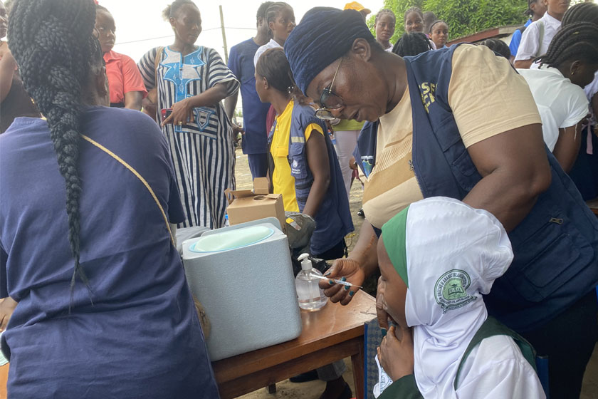 Another student at the launch receives her HPV vaccine.