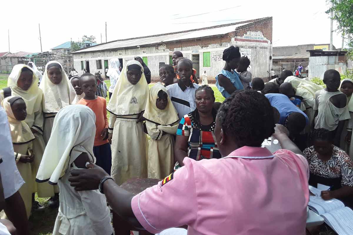 The vaccination team moved around with a data recorder (left) to ensure that every person who received the vaccine was accounted for. Credit: Joyce Chimbi