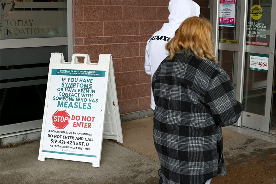 Warning signage for suspected cases of measles is seen outside the main entrance of Woodstock General Hospital in Woodstock, Ont., on May 22, 2025. Credit: THE CANADIAN PRESS, Nicole Osborne