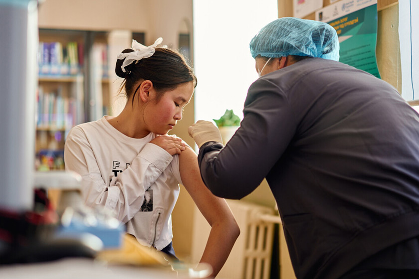 Anirlan receiving the HPV vaccine. Dolgormaa Tumurbaatar, vaccinator, also pictured. Credit: Gavi, Khasar Sandag