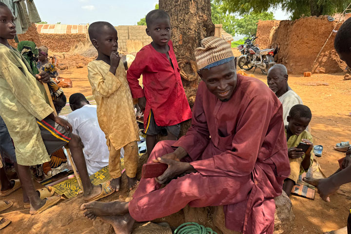 Murtala Aliyu (village head) and children at the CHAN REACH vaccination site providing support in Tung settlement, Wurno LGA, Plateau State. September 2025. Credit: Maureen Onah