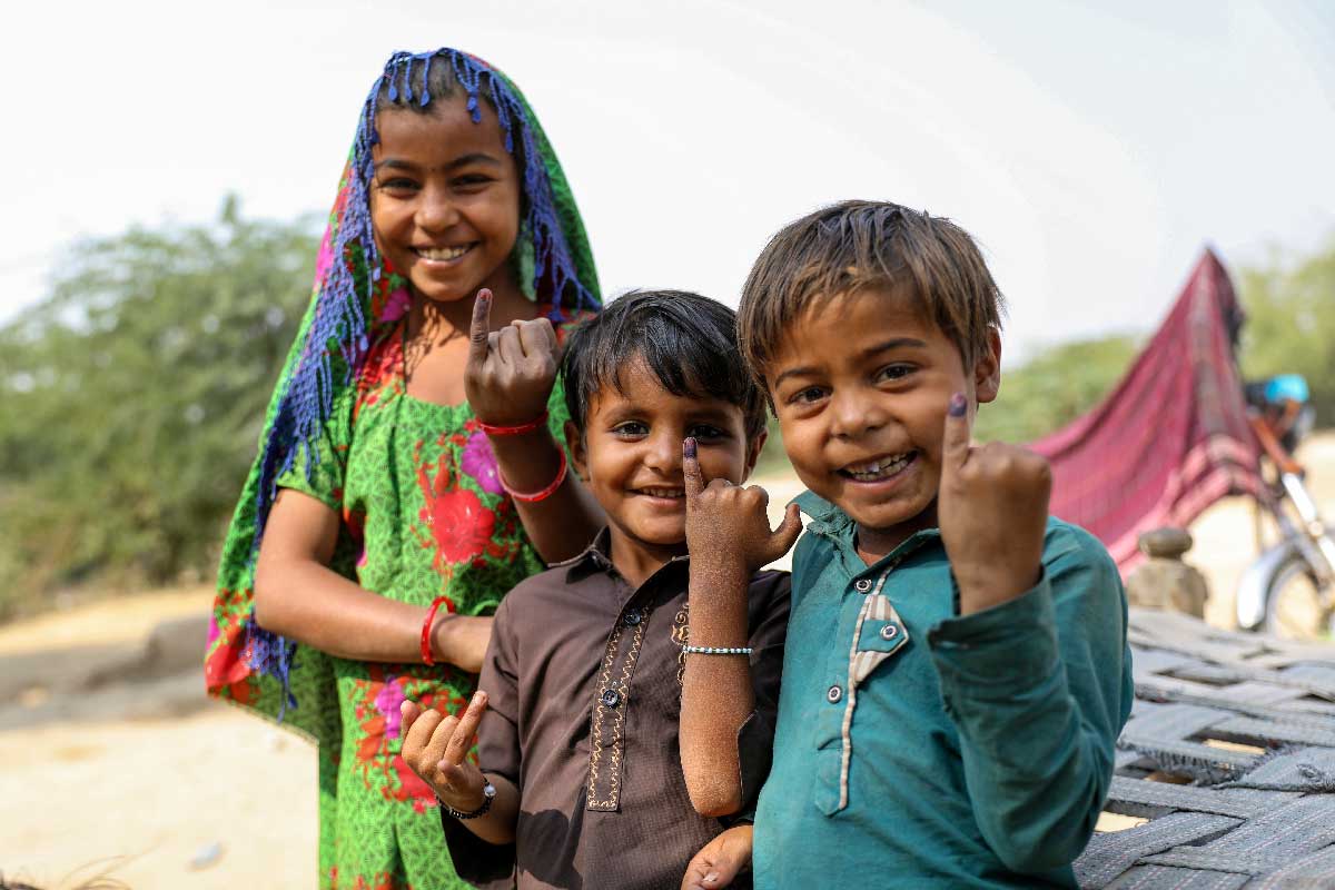 Young boys and girls proudly show the ink mark on the tip of their finger, showing they have been vaccinated against measles and rubella during the nationwide campaign in Sindh province, Pakistan. Credit: Gavi/2021/Asad Zaidi