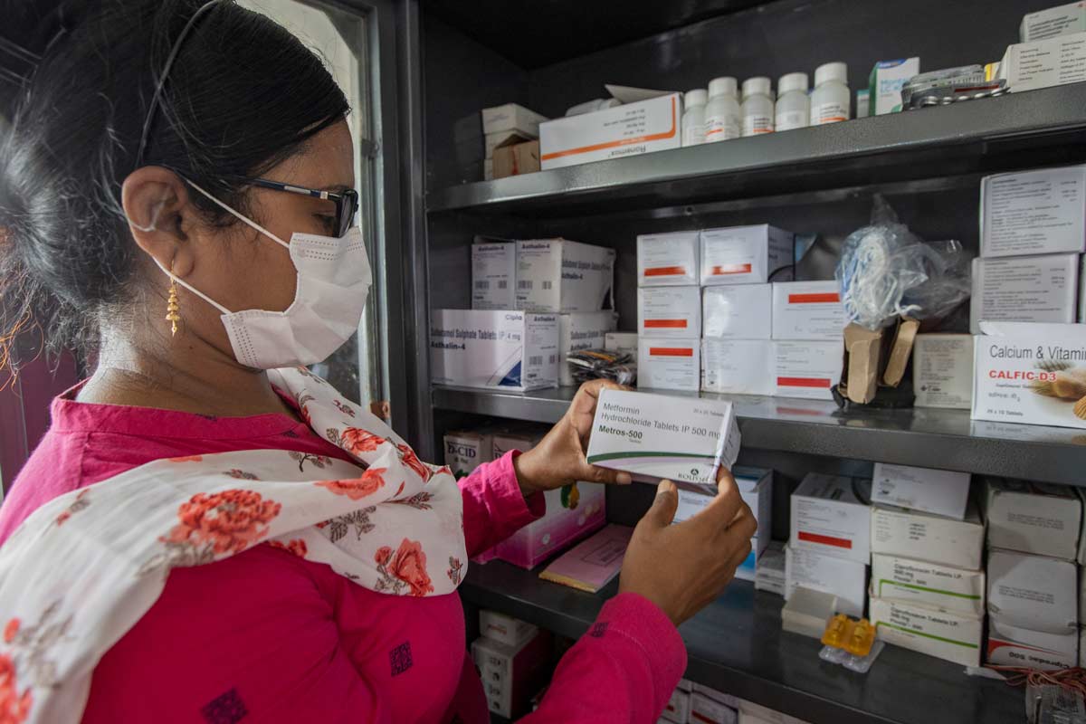 A Nurse examines medicine on bord a hospital boat, Sunderbarns, India. Credit: Gavi/2022/Benedikt v.Loebell