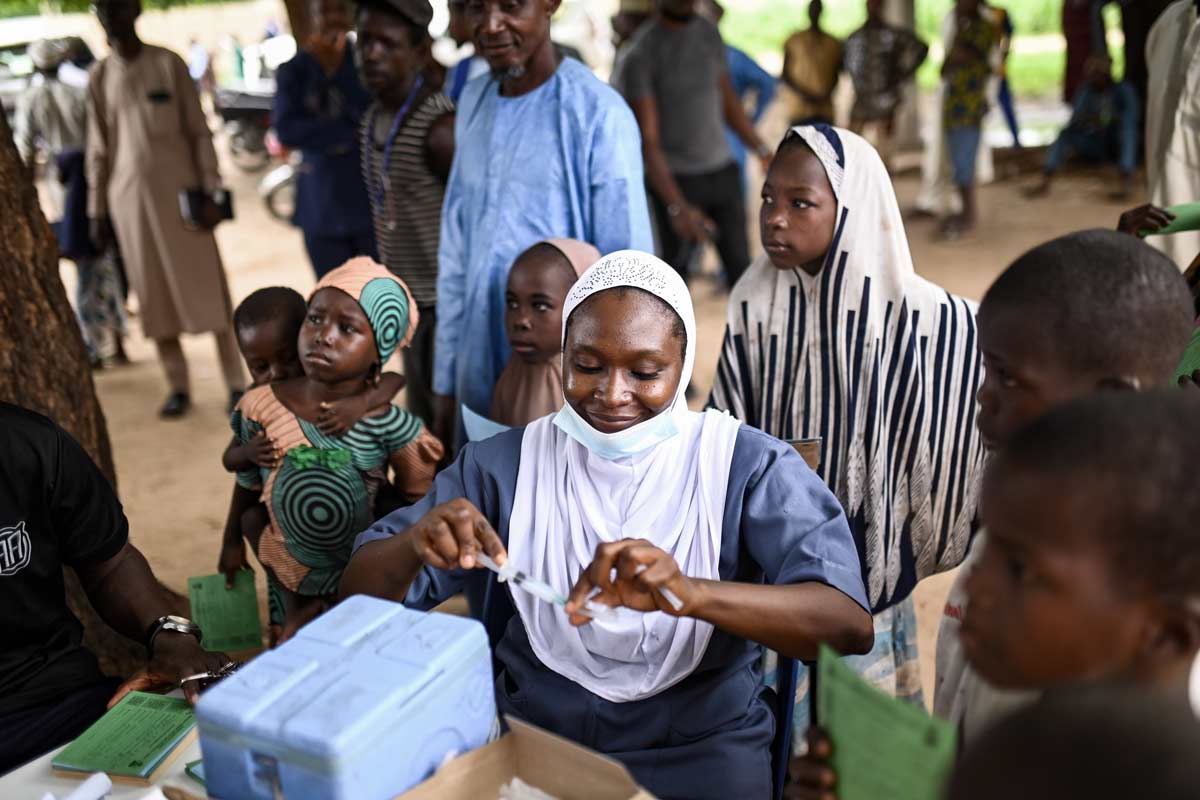 A health care worker prepares to administer yellow fever vaccine to a child at the Duhuma Health Post, Nigeria. Credit: Gavi/2023/Nr Dambali
