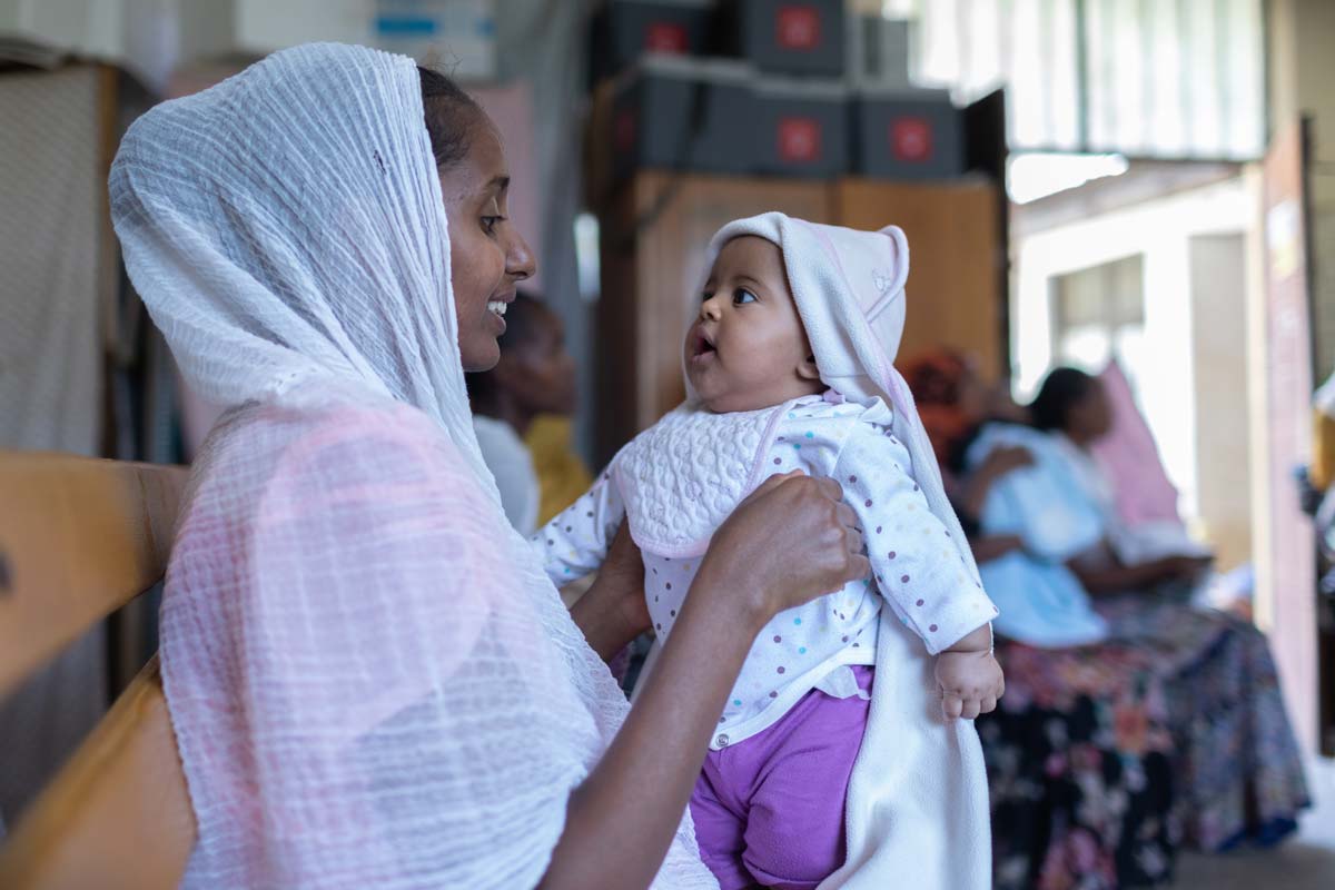 A mother holds her child while attending a measles vaccination session in the Tigray Region of Ethiopia. Credit: Gavi/2024/Mulugeta Ayene