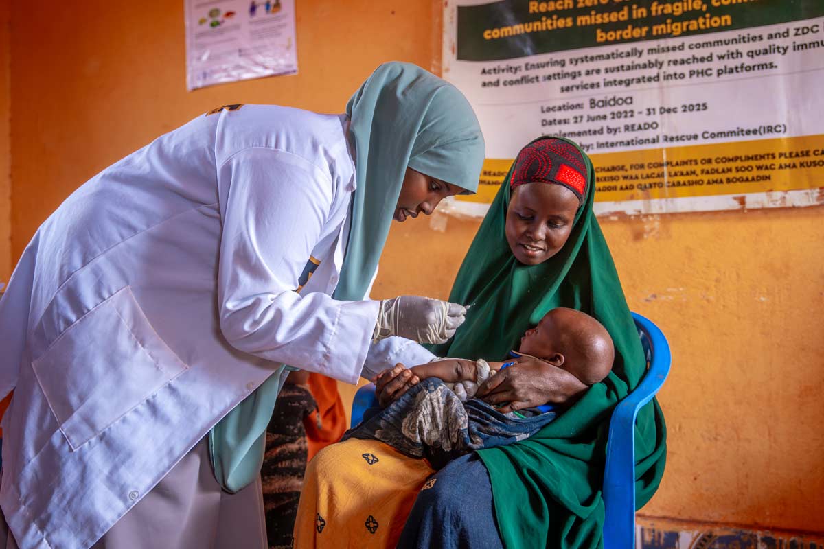 A health worker administering a vaccine to a child as he is held by his mother as part of the Reach Zero Dose Children (ZDC) campaign in Somalia, aimed at identifying children who have not received any vaccines, or communities missed by the healthcare system. Credit: Gavi/2024/Mohamed Abdihakim Ali