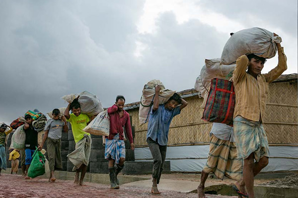 Rohingya refugees relocating because of flooding and landslides in the Balukhali refugee camp in Cox's Bazar, Bangladesh in 2019. A new study indicates that in some situations, vulnerable populations are simply unable to leave, even if they want to. Credit: UN Women/Allison Joyce