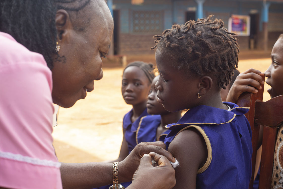 Sierra Leone makes HPV vaccine available to girls across Sierra Leone, vaccinating more than 150,000. A pupil at War Wounded Primary School in Grafton District, receives her vaccination. Credit: Joshua ​Kamara