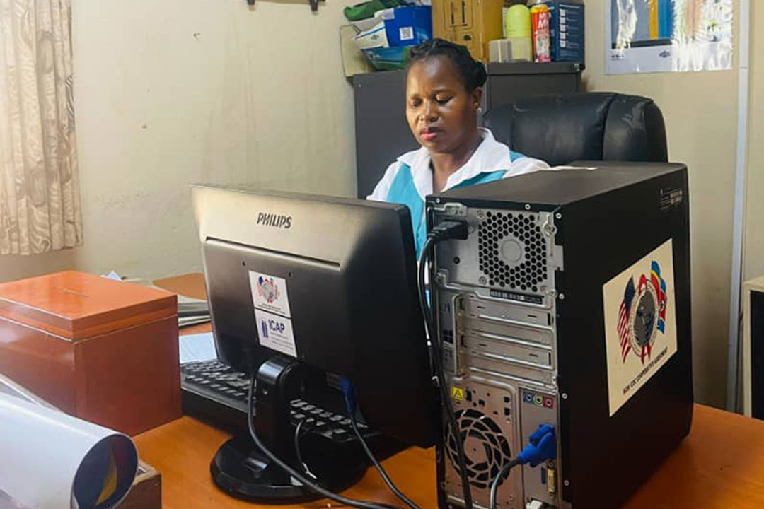 Thuli checking data at Lomahasha clinic