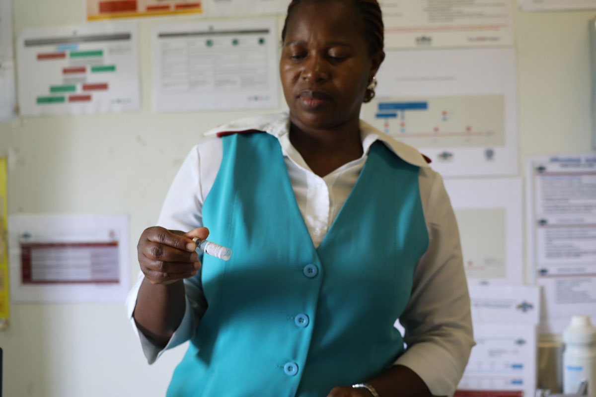 Sister Thuli Magagula checking vaccine potency at Nkonjwa clinic. Credit: Mpendulo Dlamini, Health Promotion Unit