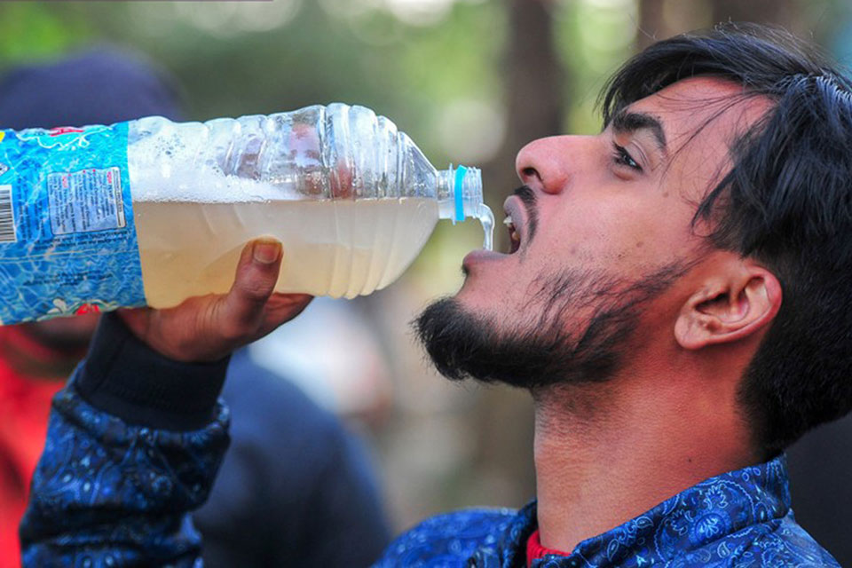 A young man drinking raw date palm juice on the outskirts of Sylhet city. Credit: CEPI