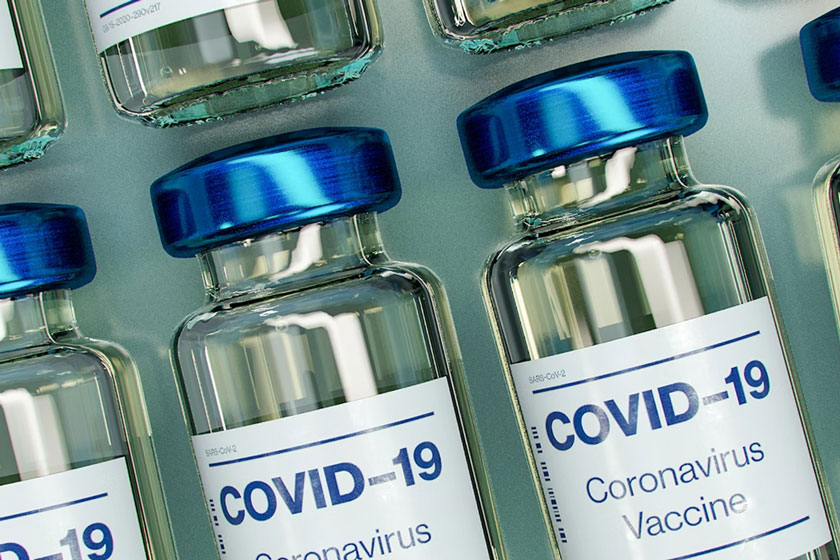Blue and white plastic Covid-19 vaccine vials. Credit: Daniel Schludi