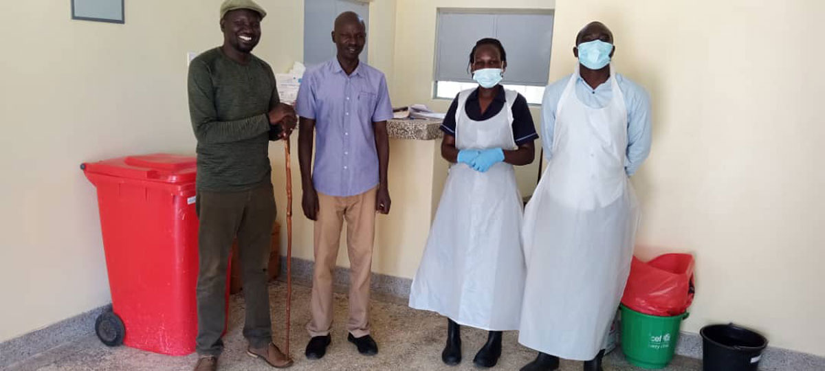 Dr Ocula (second from left) and other volunteers after cleaning the makeshift cholera ward at Agoro Health Centre III. Credit: Denis Ocula