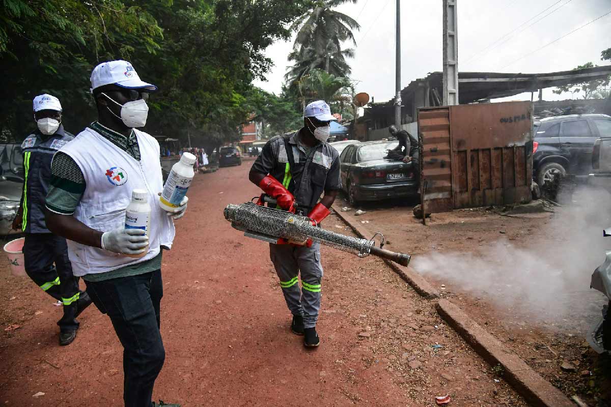 Public health officials spray the streets in Abidjan, Côte d'Ivoire, in 2023 to eliminate mosquitoes that cause dengue fever. Sia Kambou/AFP/Getty Images