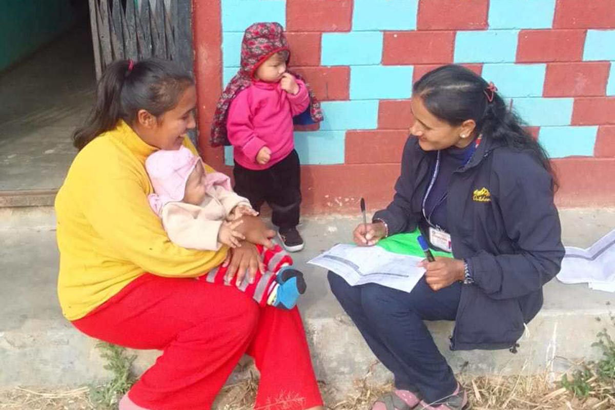 Health workers going door to door to check if children have received their vaccinations. Credit: Radha Poudel