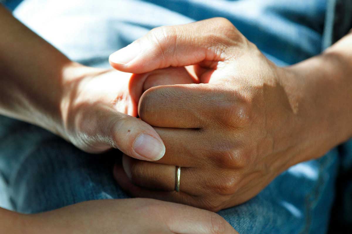Holding hands. Credit: National Cancer Institute/Unsplash