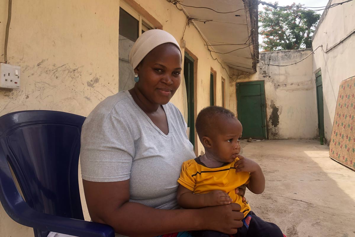 Happy Nambala holds her son feeling confident that her son is fully vaccinated. Ekpali Saint