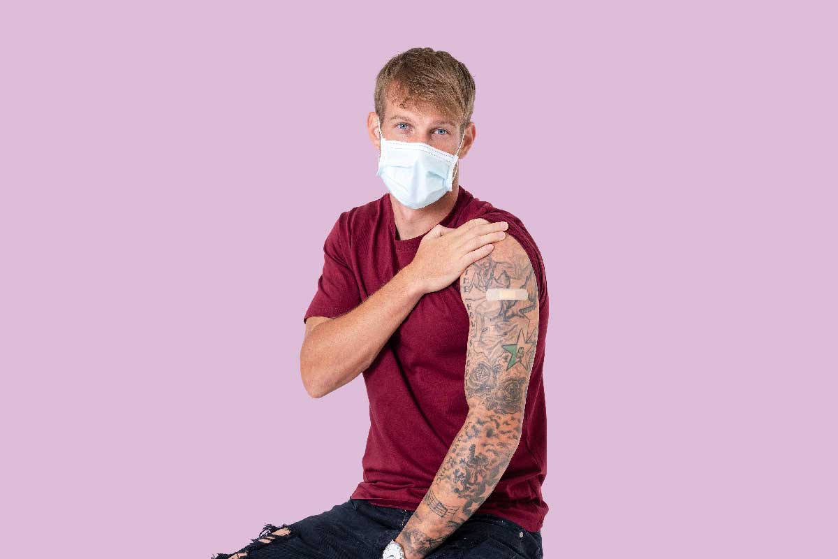 A man presenting a tattooed shoulder post-vaccination. Credit: RawPixel/Freepik