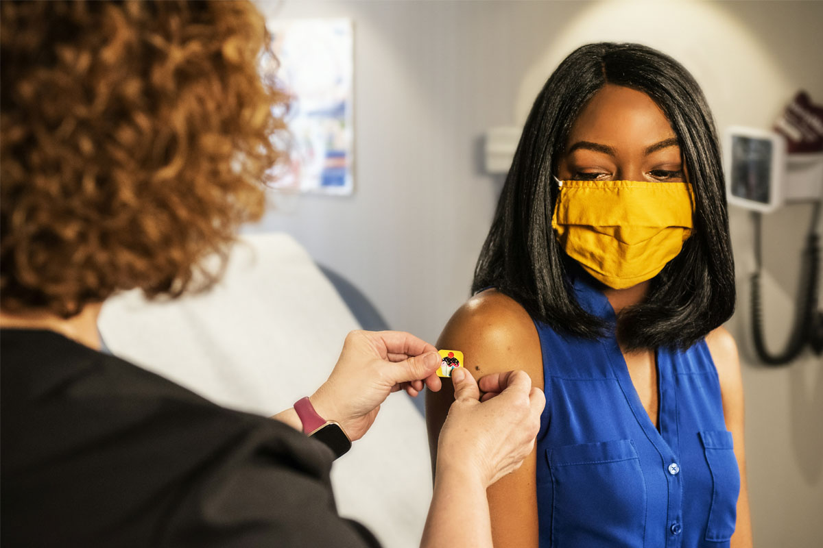 Health worker places a plaster on a patient’s arm after vaccination. Credit: CDC via Unsplash