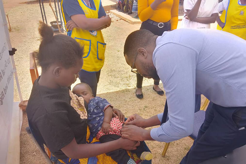 A mother holds her baby as they are given the malaria vaccine at Lumezi Urban Clinic. Credit: Temwanani Mtonga