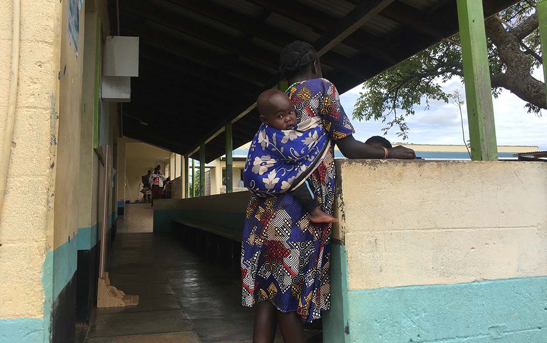 A mother with her six-months-old baby on her back, at Kanyarkwat Helath Center. Credit: Pius Sawa