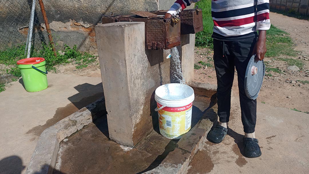 A resident fetches water from a community water source. Previously, some boreholes were reported to be contaminated Credit Derick Matsengarwodzi