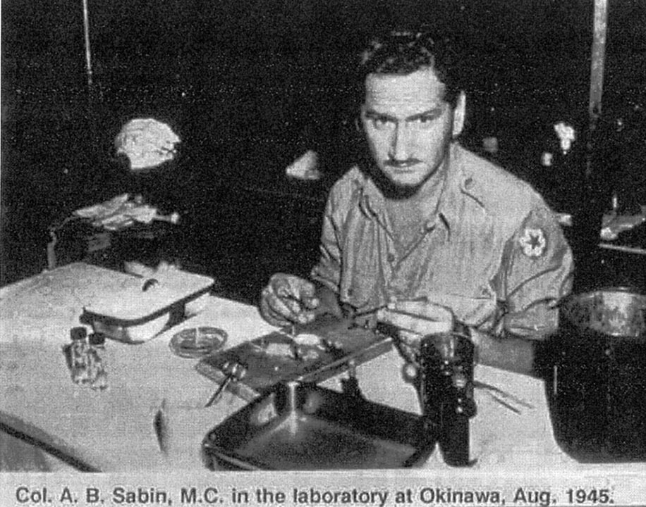 Fig. 3. Albert Sabin performing assays for Japanese encephalitis antibody in a tent in Okinawa. From WRAIR Archives.