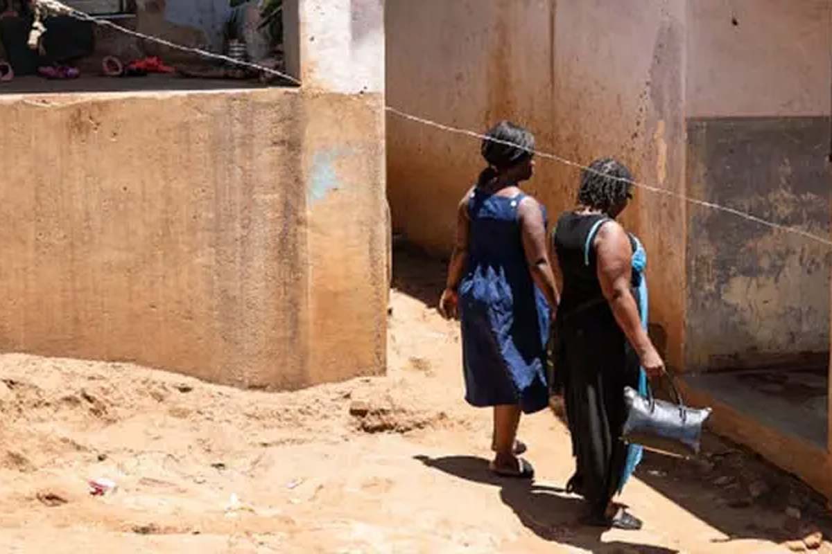Patricia, pictured left walking with her sister, lost her vision due to cryptococcal meningitis. Scientists say that if people know the signs and symptoms of the disease, they will rush to the hospital for treatment. Photo courtesy of DNDi.