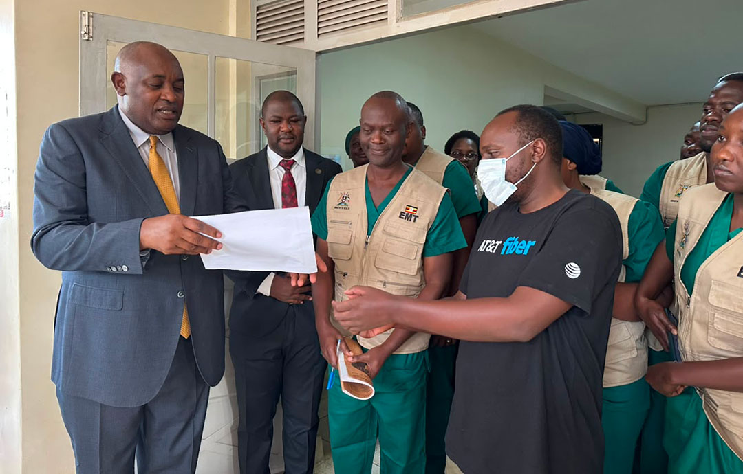 Dr Chris Baryomunsi, Uganda’s Minister of Health, handing a discharge certificate to a survivor of Ebola at the Isolation Unit in Kampala. Credit: Emmanuel Ainebyoona