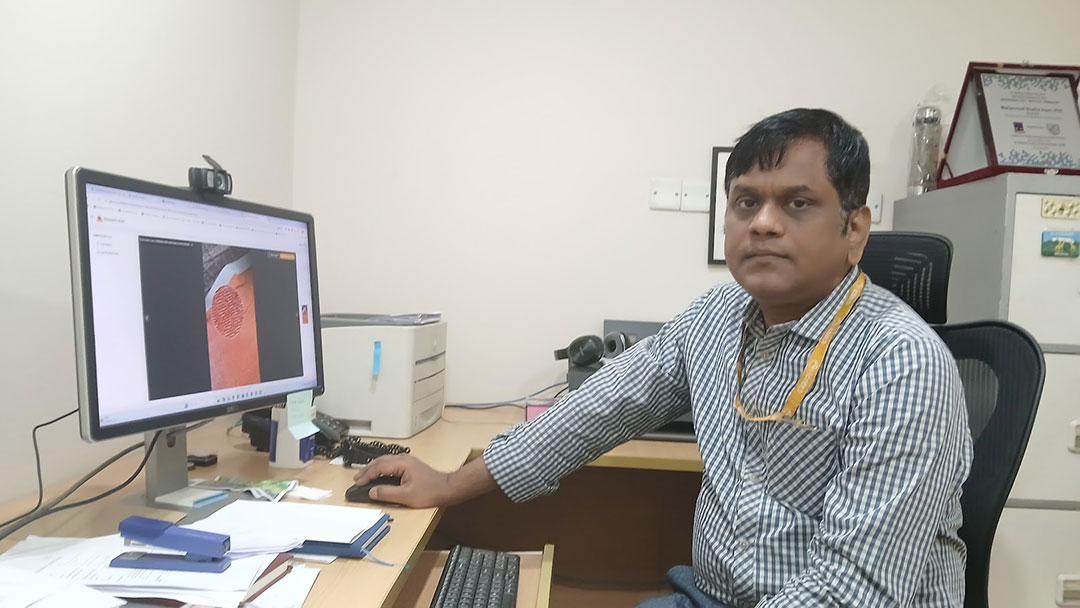 Dr Mohammad Shafiul Alam, Scientist at icddr,b working with the Mosquito Alert app at his office. Credit: Mohammad Al Amin