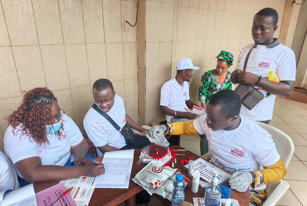 Health workers screen blood samples for sickle-cell trait. While people with just one copy of the sickle-cell haemoglobin gene can live symptom-free, they are carriers and at risk of producing children with the full-blown disease. Credit: Programme national de lutte contre les maladies non transmissibles