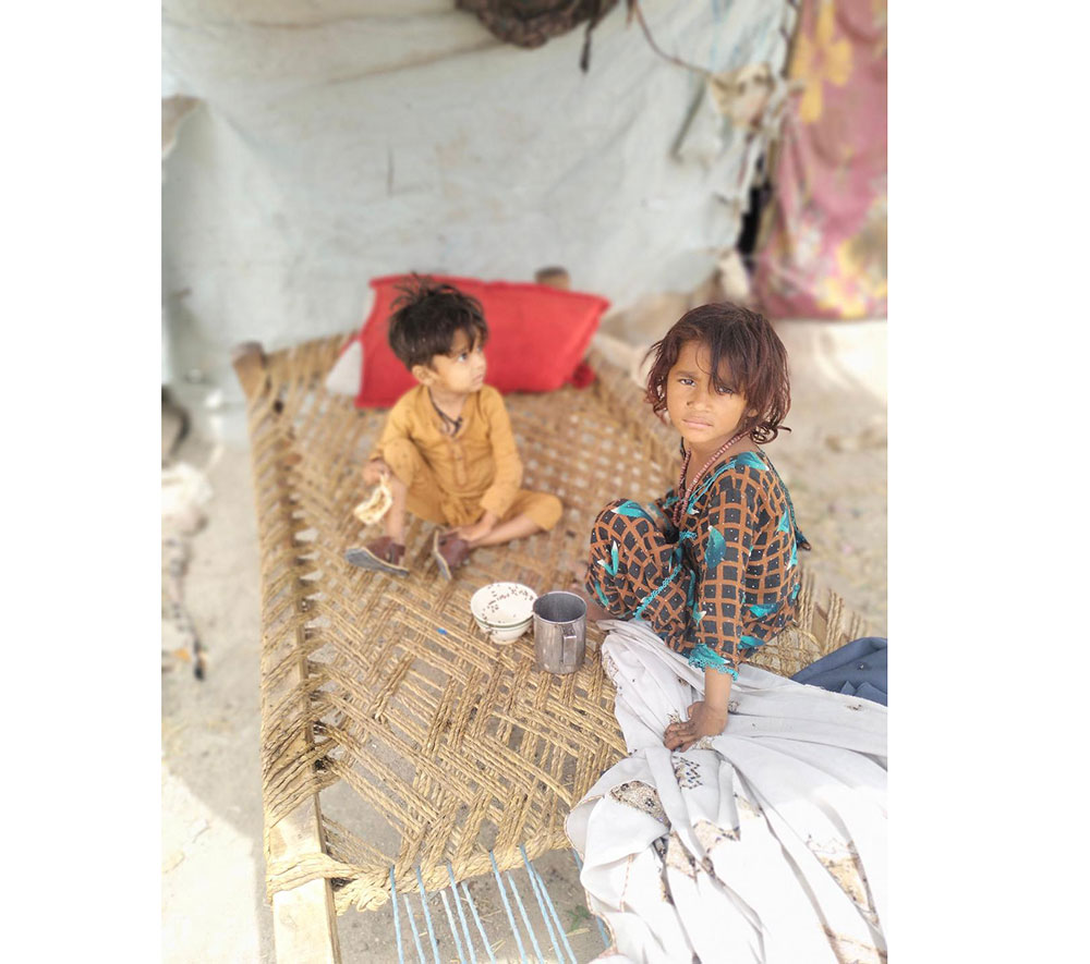 Five-year-old Noor Fatima and her brother, three-year-old Muhammad Hussain, at makeshift settlement on the outskirts of Peshawar. Credit: Adeel Saeed