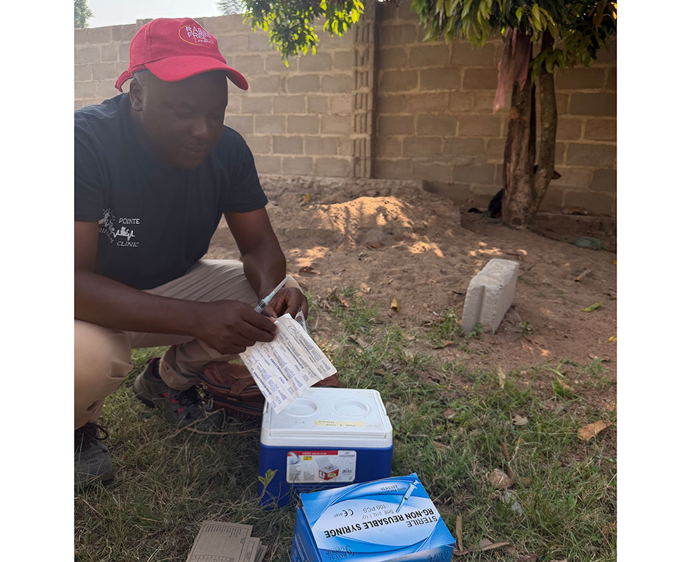 Ahmed Lugelo prepares rabies vaccines ahead of a vaccination session in the rural Tanzanian village of Nyamoko. Courtesy Rabies Free Africa