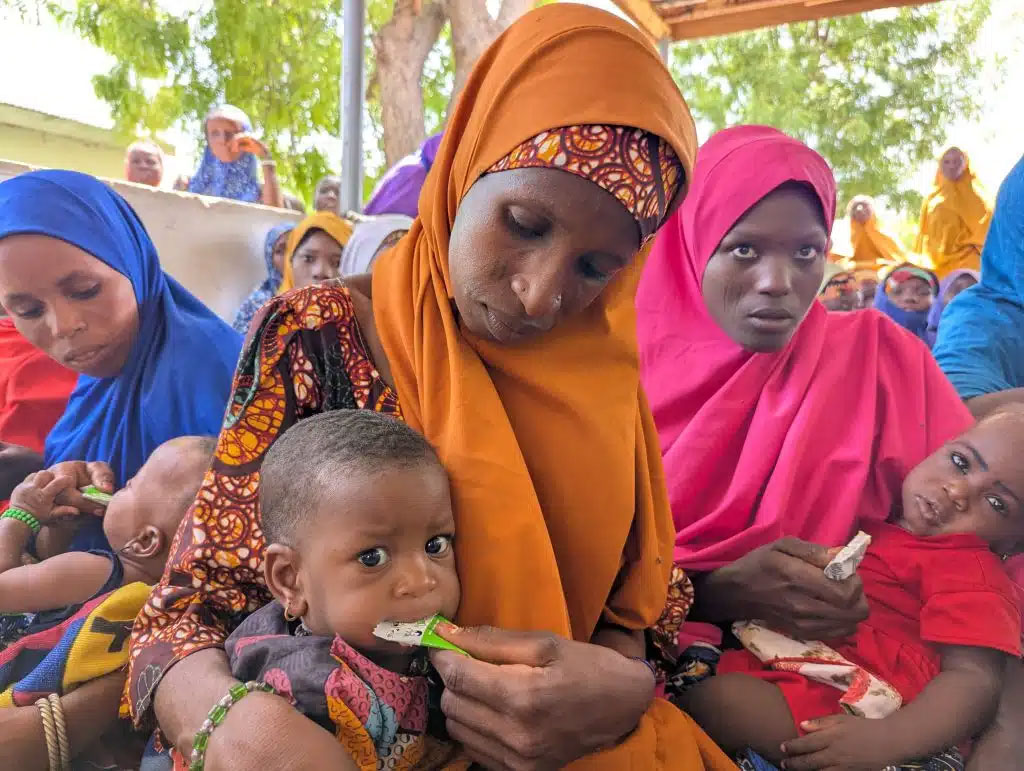 Mothers giving their children SQ-LNS during immunisation at Karasuwa Galu PHC. Credit: Afeez Bolaji