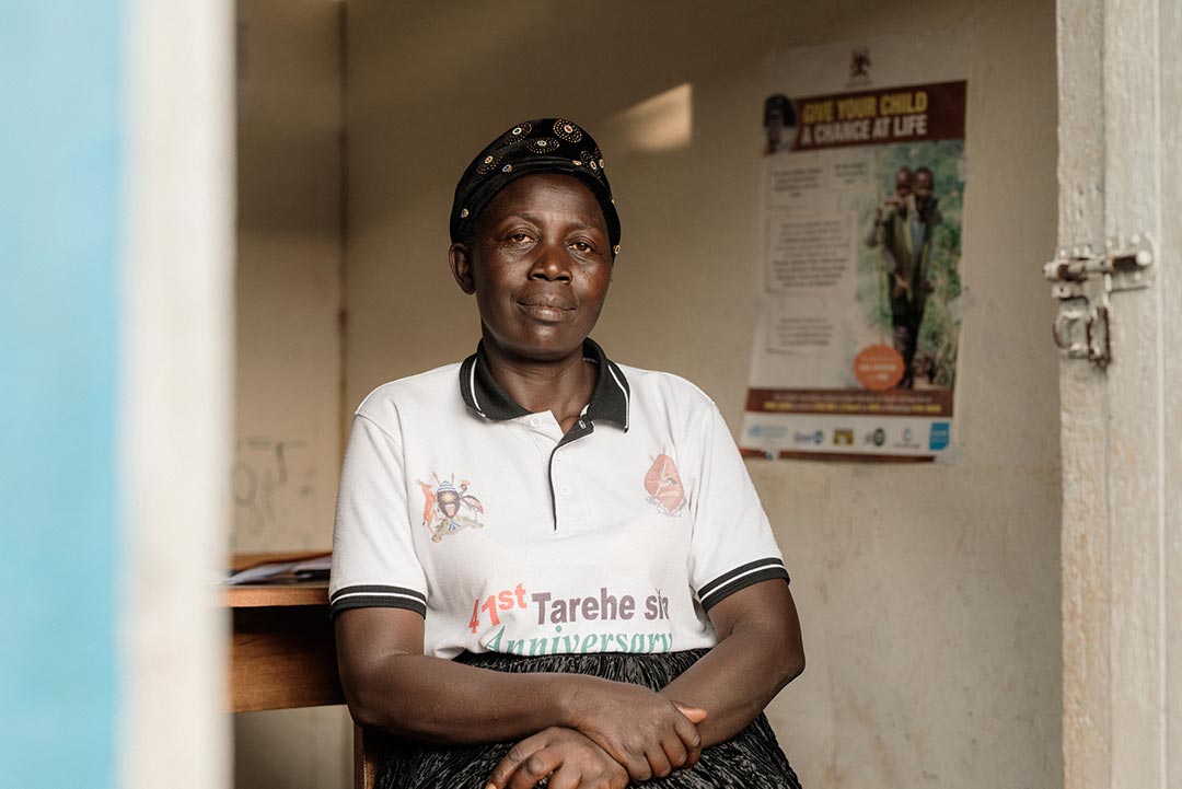 Neumbe Irene poses for a photo at Buhugu HC III, Sironko District where she works as immunisation champion. Credit: PATH, Robert Kayemba