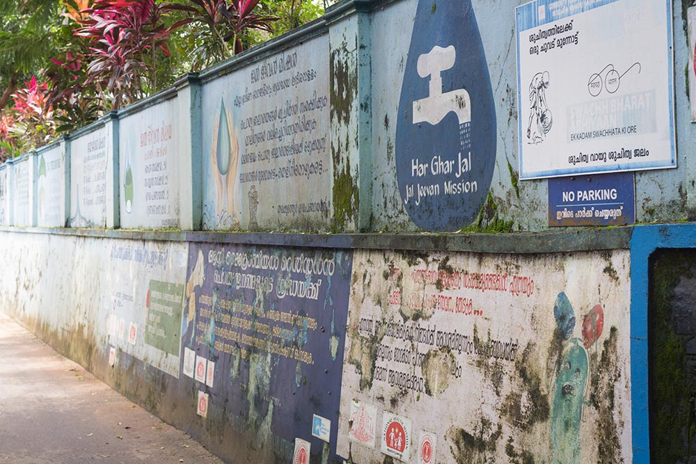 While schemes to increase coverage of treated piped water and promote its use is ongoing, public preference for dug well-water poses a challenge for health workers in Keralam. In pic: Public messaging about Jal Jeevan Mission, which aims to provide tap water to every rural household, schools and Anganwadi centres. Credit: Jeff Joseph Paul