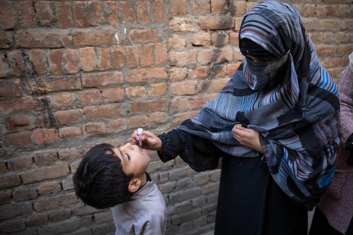 A health worker administering polio drops to a child in Pakistan. Credit: Gavi/2020/Asad Zaidi.