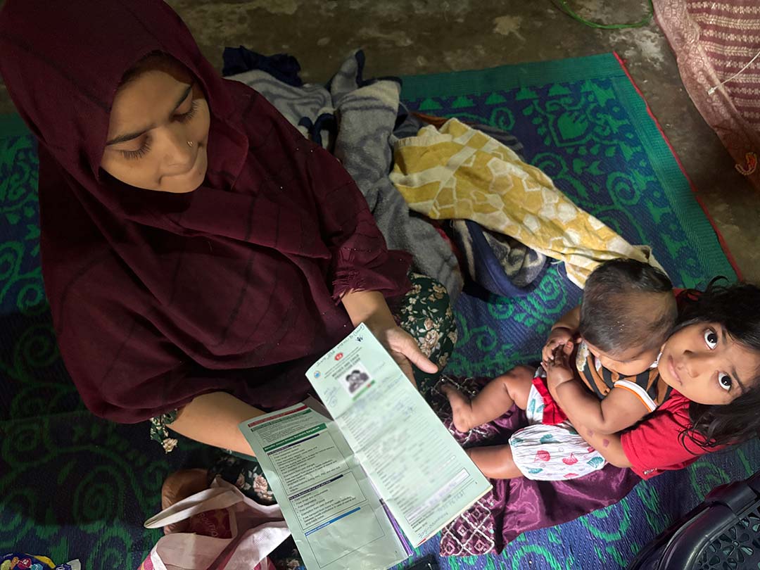 Rashida Begum shows her children's immunisation card issued by the Ministry of Health. Credit: Raihana Maqbool