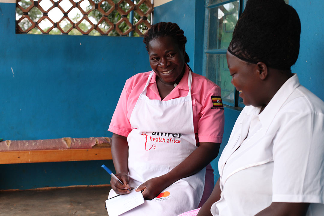 Ruth Gokyalya consults with Rebbecca Nabiryo. Credit: John Musenze