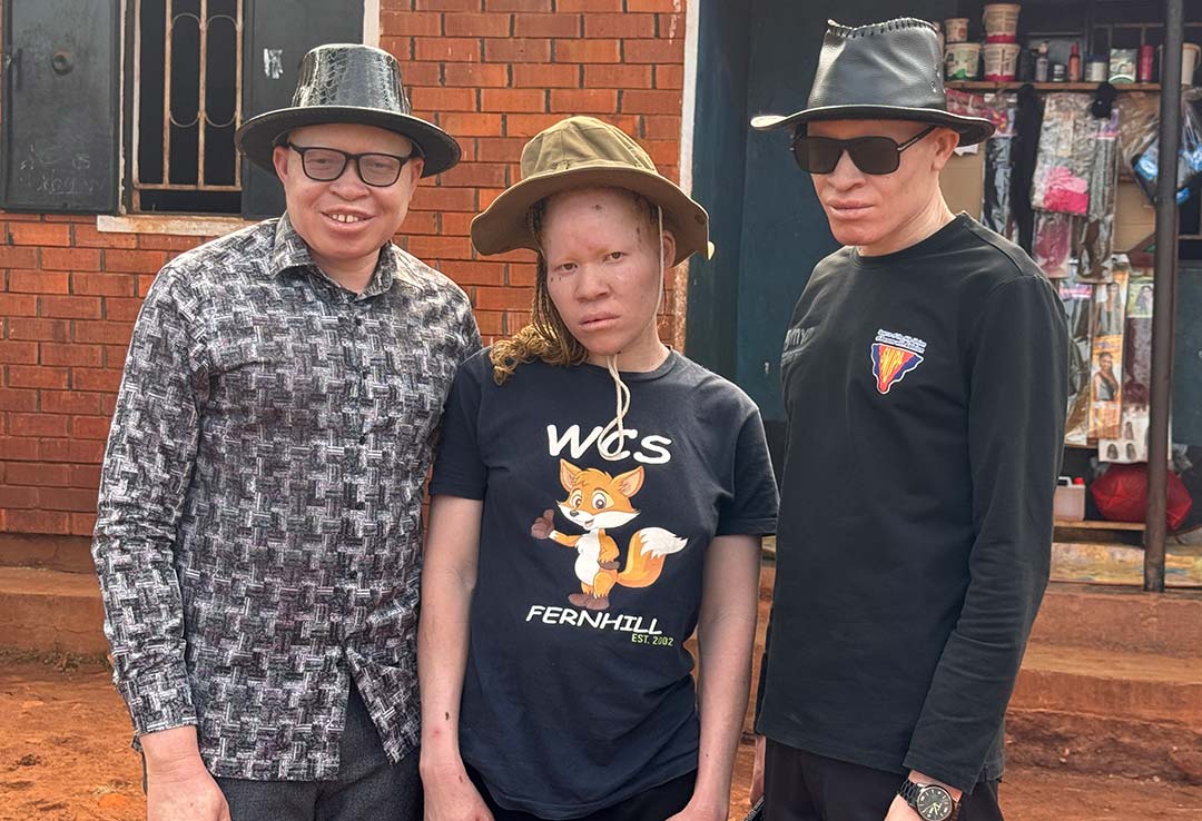 Sharon Nakawala (in the middle) standing in between members of SNUPA inclusing Ogik Peter on left who had gone to check on him and her son. Credit: John Musenze