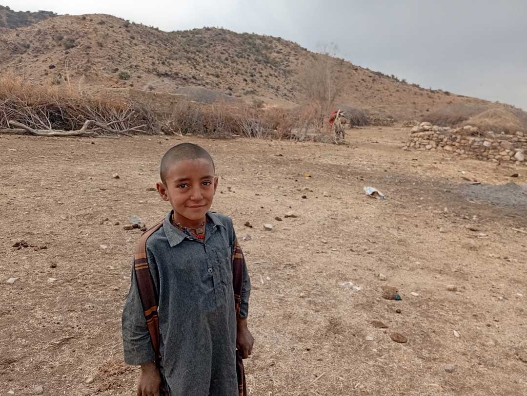 Asif's elder brother in front of his hut.