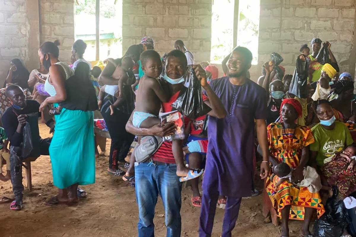 Fathers bring their children to be vaccinated, as part of the Gender Model Family training programme. Credit: Focus 1000, Sierra Leone