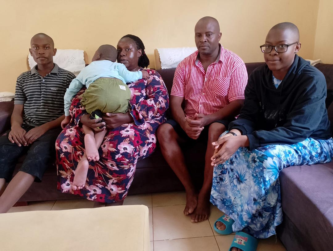 Joshua at home with his family, including his older brother Smith, who saw to it that Joshua received all his routine childhood immunisations. Credit: PATH/Peter Abwao 