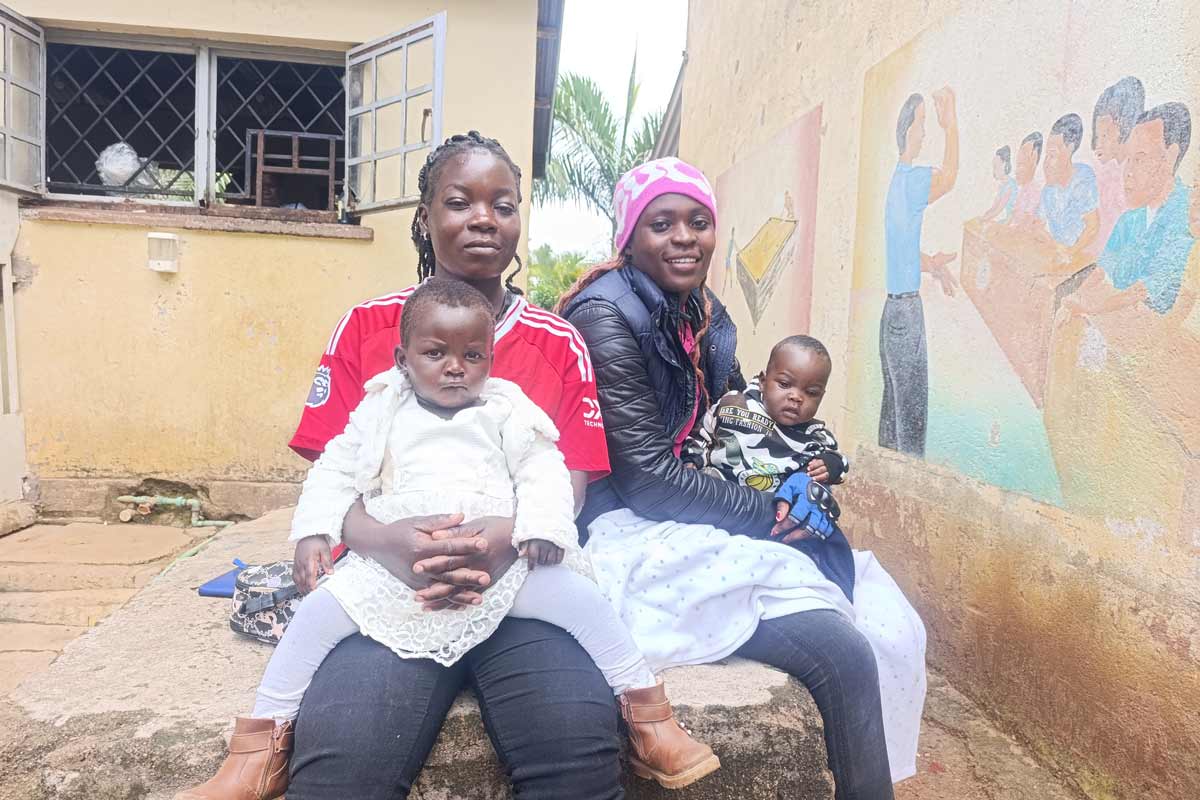 From left: Immaculate Achieng and her two children pose for a photo alongside Brenda Awuor, a female motorbike rider. Credit: Angeline Anyango.