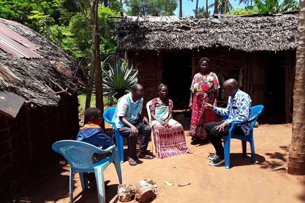Chimwaga Mwamuye, right, is the County Malaria Control Coordinator for Kilifi. He has accompanied a community health promoter for a household visit. Credit: Joyce Chimbi